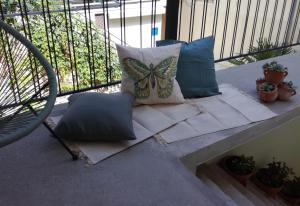 a bench with pillows on a balcony with a butterfly pillow at Apartment Mila Krk in Krk