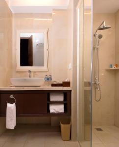 a bathroom with a sink and a shower at Gallery Prawirotaman Hotel in Yogyakarta