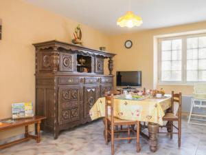a dining room with a large wooden cabinet and a table at Gîte Rouans, 2 pièces, 4 personnes - FR-1-306-830 in Rouans