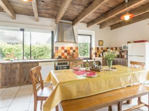 a kitchen with a table with a yellow table cloth on it at Gîte Guémené-Penfao, 4 pièces, 7 personnes - FR-1-306-1130 in Guéméné-Penfao