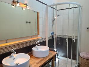 a bathroom with two sinks and a shower at Gîte 4 pers. avec terrasse privative entre Sologne et Châteaux de la Loire - FR-1-590-36 in Cléry-Saint-André +9 photos