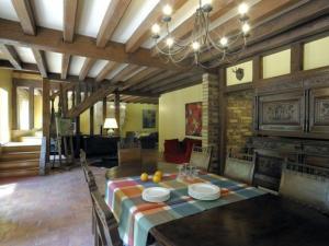a dining room with a table and a fireplace at Maison Rustique Familiale en Sologne avec Grands Espaces, Proche Châteaux de la Loire - FR-1-590-1 in Ardon