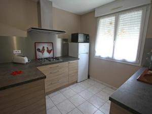 a kitchen with a white refrigerator and a window at Charmant apt avec accès indépendant, terrasse, proche Épinal et activités culturelles - FR-1-589-138 in Hagécourt