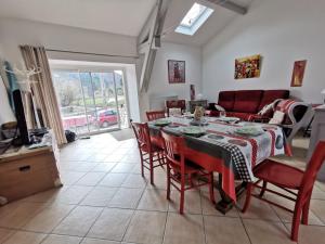 a dining room with a table and chairs and a couch at Gîte Lavoûte-sur-Loire, 4 pièces, 5 personnes - FR-1-582-238 in Lavoûte-sur-Loire