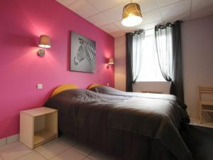 sypialnia z łóżkiem z różową ścianą w obiekcie Gîte Saint-Julien-Molhesabate, 4 pièces, 6 personnes - FR-1-582-261 w mieście Saint-Julien-Molhesabate