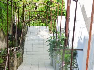een tuin met een bakstenen loopbrug met planten bij Studio for short stay in Rabac