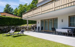 a patio with two benches and a table and chairs at Apartment Jessica in Leogang