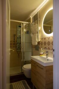 a bathroom with a sink and a toilet and a shower at Studio Acropolis in Athens