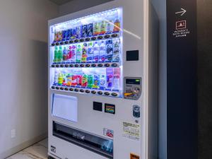 a vending machine filled with bottles of soda at Fukuoka U-BELL Hotel in Fukuoka