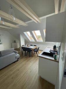 a kitchen and a living room with a table at Apartament Biały Domek in Władysławowo