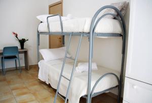 a room with two bunk beds and a table at B&B & Residence Pozzo Misseo in Matera