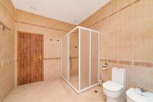 a bathroom with a shower and a toilet and a sink at Blaguna Eco Complex in Varna City