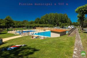 a park with several swimming pools in a park at A Casa do Lado in Melide