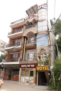 a building with a hotel in front of it at Hotel Tip Top in Solan