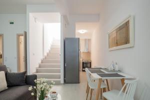 a kitchen and living room with a black refrigerator at Eleni's Studio in Heraklio Town