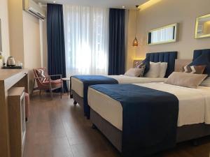 Postel nebo postele na pokoji v ubytování Nobel Hotel