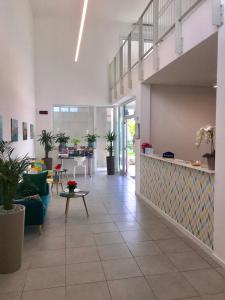 a large room with a lobby with plants at Sisan Family Resort in Bardolino