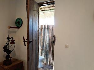 a door that is open to a room with a door at La Boheme Bajo in Labuan Bajo