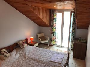a bedroom with a large bed and a window at AMAZING SEA VIEW Guest House ADRIATICA in Kotor