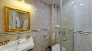 a bathroom with a shower and a sink and a mirror at Maria Palace Complex in Balchik +83 photos