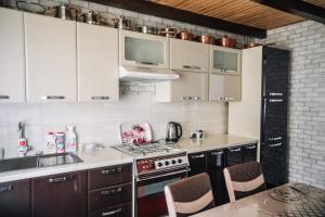 a kitchen with white cabinets and a stove top oven at Стежка в гори in Verkhovyna