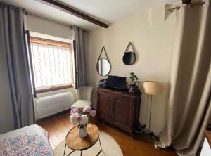 a living room with a vase of flowers on a table at Studio au cœur du Vieil Antibes in Antibes