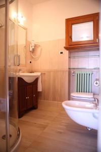 a bathroom with a sink and a toilet and a mirror at Sweet Appartment di Guido in Peschiera del Garda