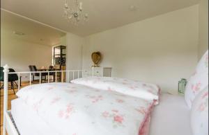 a bedroom with two beds and a chandelier at Rapunzel in Neuenbürg