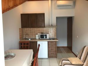 a small kitchen with a table and a microwave at AMAZING SEA VIEW Guest House ADRIATICA in Kotor +43 photos