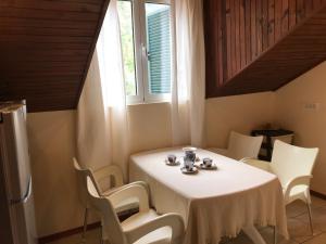 a white table with white chairs and a window at AMAZING SEA VIEW Guest House ADRIATICA in Kotor