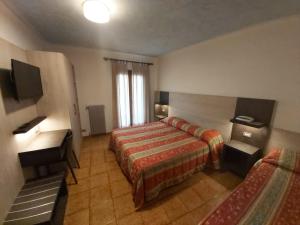 Postel nebo postele na pokoji v ubytování Albergo Ristorante K2