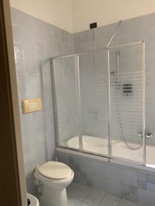 a bathroom with a shower and a toilet and a tub at Altrove in Cagliari