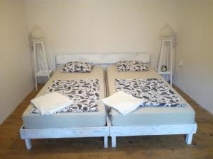 two twin beds in a room with two pillows at Apartment Mila Krk in Krk +11 photos