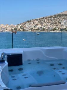 a bath tub with a view of the water at Demi Hotel in Sarandë