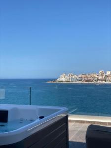 a bath tub with a view of the water at Demi Hotel in Sarandë