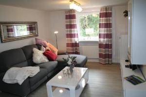 a living room with a couch and a coffee table at Ferienwohnung Haus Zeier in Hahnenklee-Bockswiese