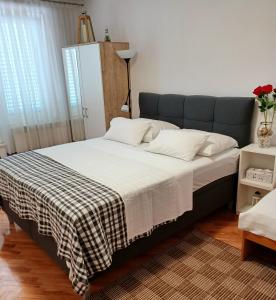 a bedroom with a bed with a checkered blanket at Rooms & Apartments Dolac in Hvar