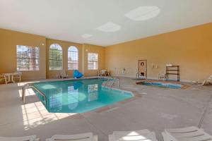 a large swimming pool in a large room with chairs at Comfort Inn Payson in Payson