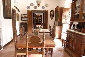 a kitchen with a wooden table in a room at Casa El Carmen in Ciudad Real