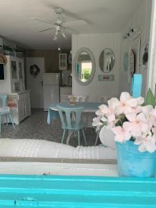 a kitchen and dining room with a table and flowers at Petite house in Starigrad-Paklenica