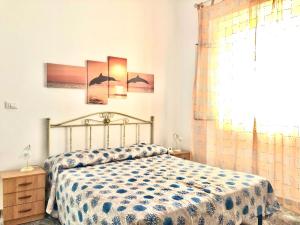 a bedroom with a bed and a window at Sunset Salentorelax San Gregorio in Marina San Gregorio