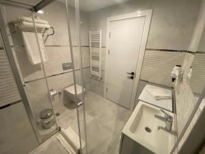 a bathroom with a shower and a sink and a toilet at Viva Suites Cappadocia in Nevşehir +154 photos