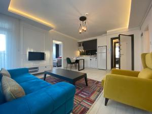a living room with a blue couch and a table at Viva Suites Cappadocia in Nevşehir