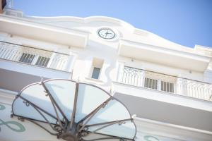 a building with a clock on the side of it at Princier Fine Resort & SPA in Rimini