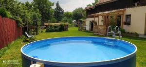 a large hot tub in the yard of a house at Apartment 2 in Hrabušice