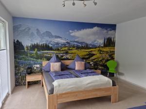a bedroom with a bed with a mountain mural on the wall at Ferienwohnung Vier Pfoten in Willingen +77 photos