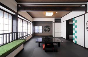 a room with a table and a green couch at Goyokan in Izu