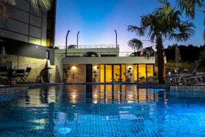a swimming pool in front of a building at Eagles Apartments & Suites in Ulcinj