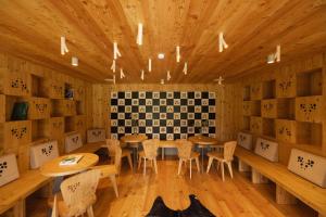 a dining room with wooden tables and chairs at Hotel Bohinj in Bohinj +37 photos
