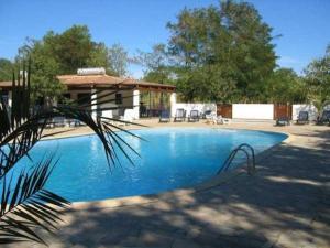 a large blue swimming pool with a gazebo at camping le Fief d'Anduze in Anduze